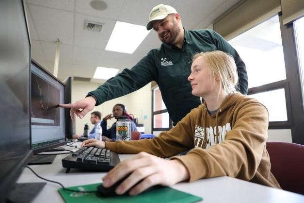 Student and professor in a classroom. 